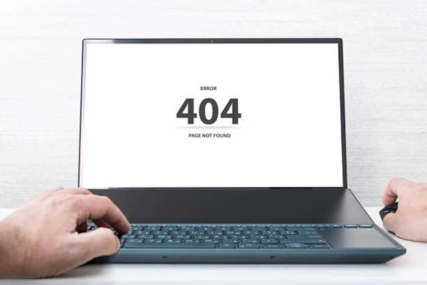 a laptop showing a 404 error: Page Not Found